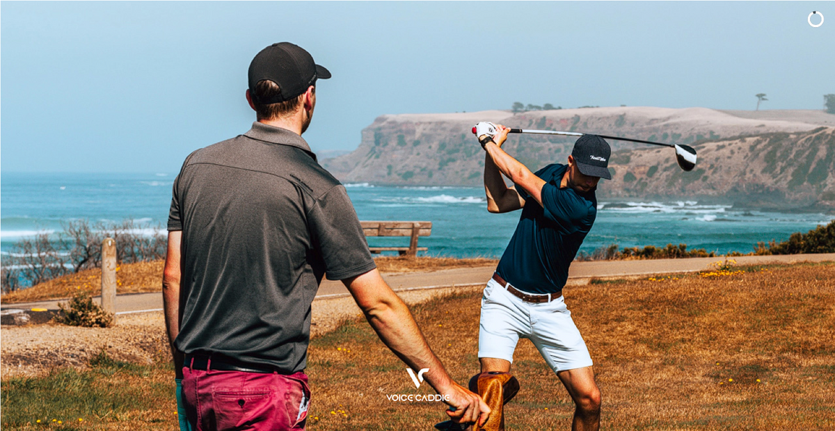 Voice Caddie Golfer Hitting Driver on Tee By Ocean